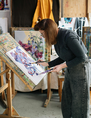 Woman painting at an easel